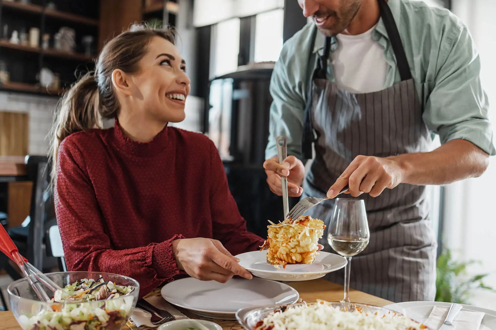 Man serving woman dinner at home