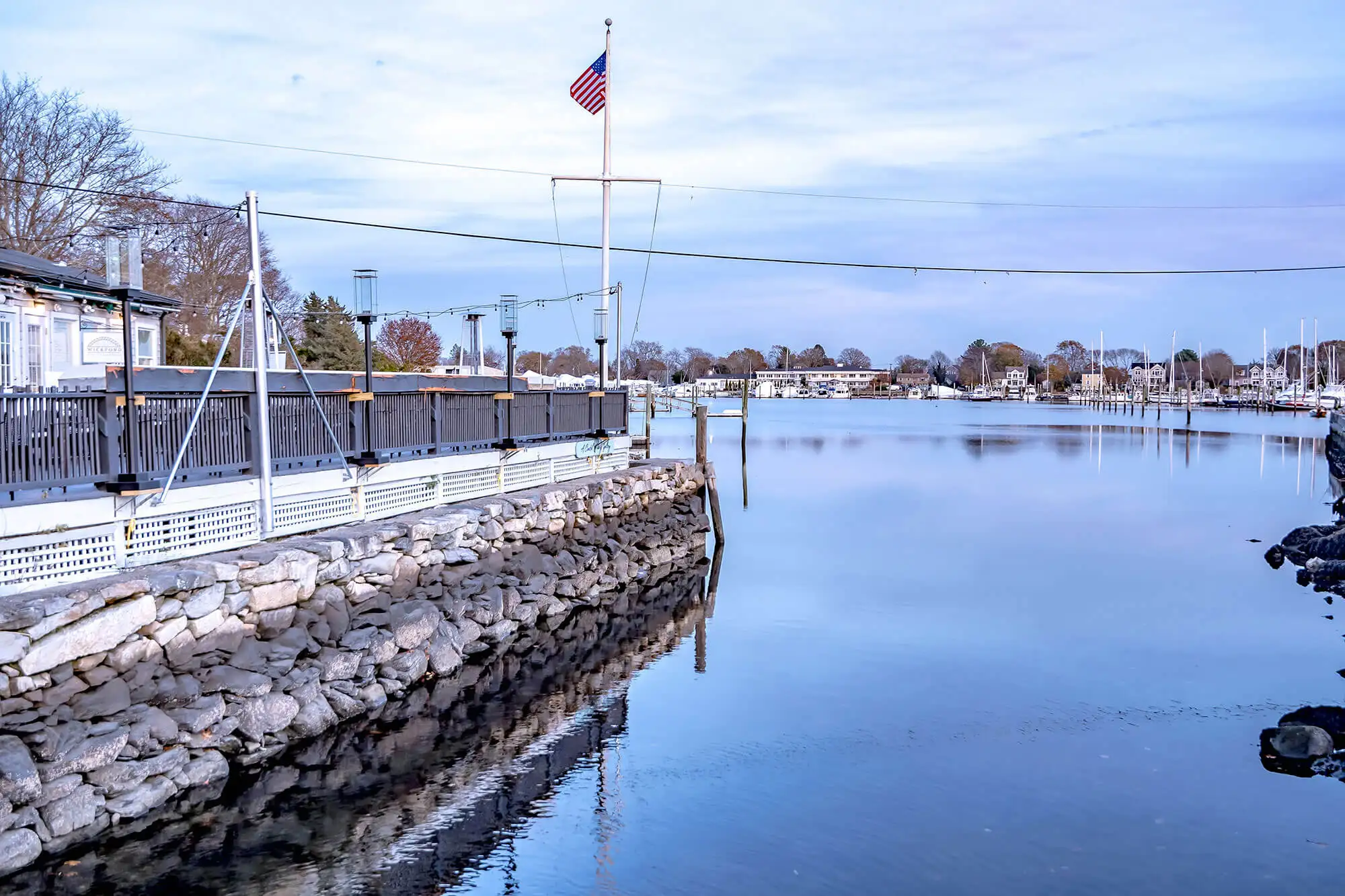 A harbor waterway with a bay side restaurant to its left